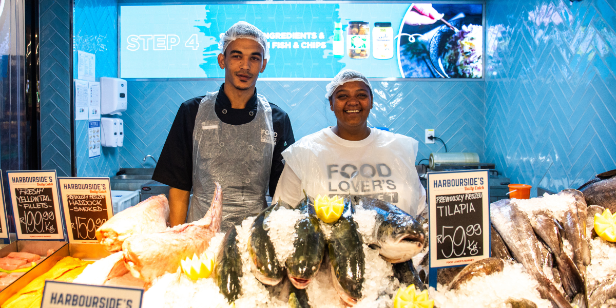 2 fishmongers behind the fish counter SASSI Fisheries Day